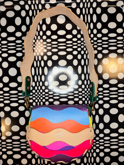 Colorful handbag with a pattern against a polka dot background